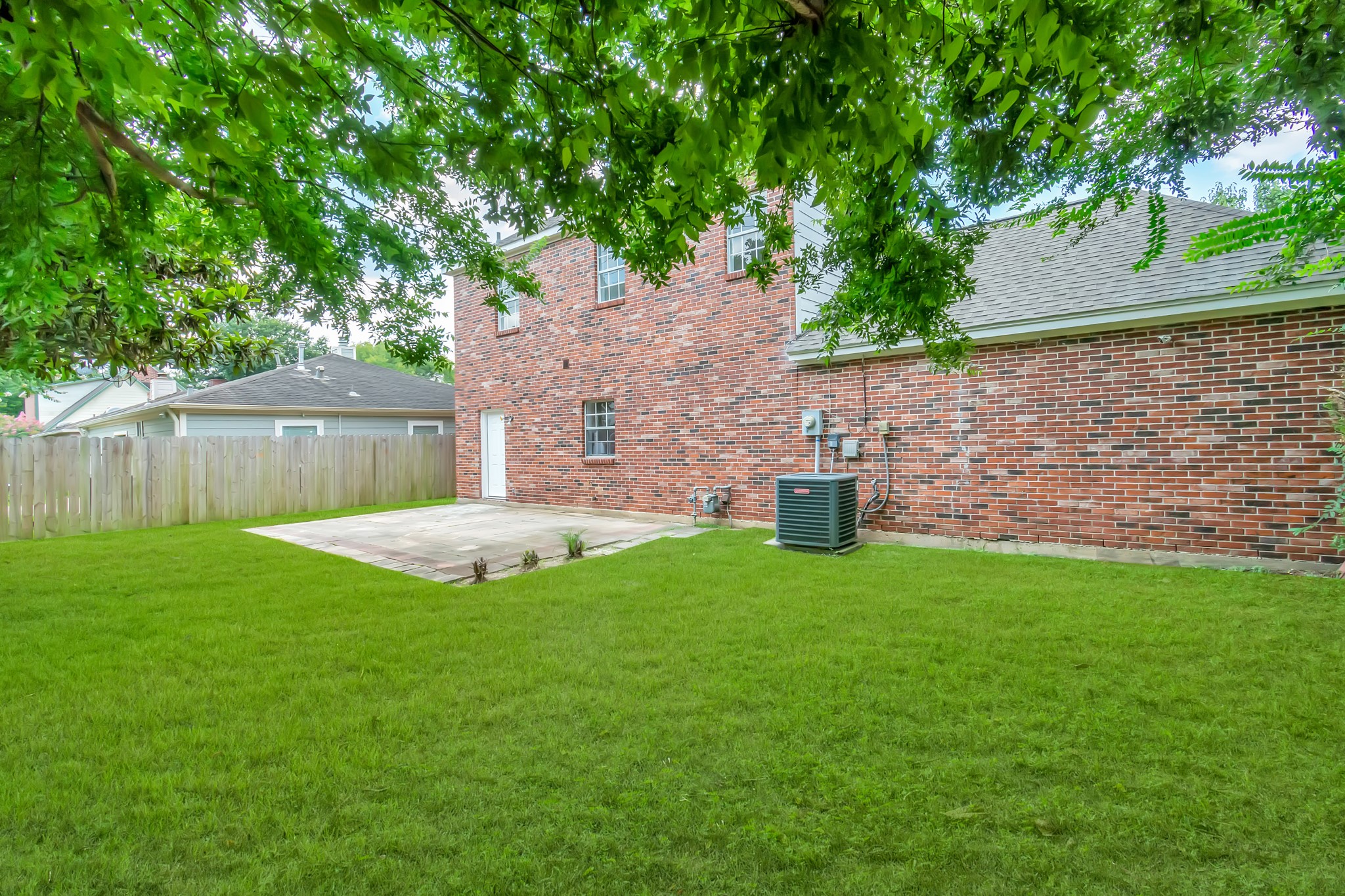 12818 Chamberlain Drive Houston, TX 77077 - Photo 30 of 32 a view of a house with backyard and a tree