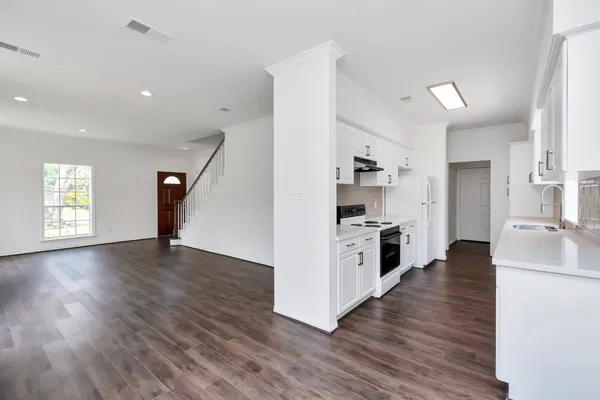 a view of kitchen with sink and wooden floor