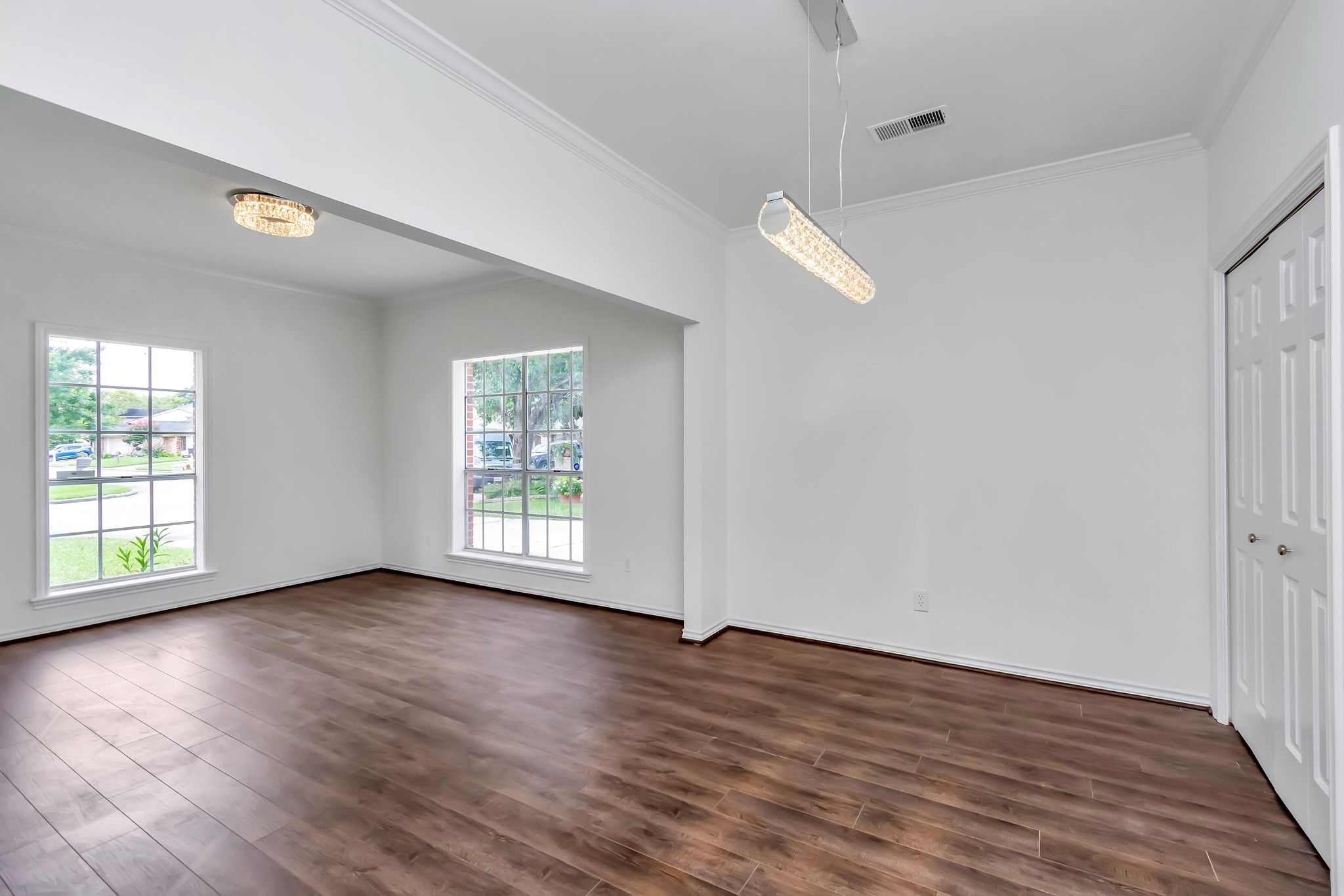 12818 Chamberlain Drive Houston, TX 77077 - Photo 8 of 32 an empty room with wooden floor and windows