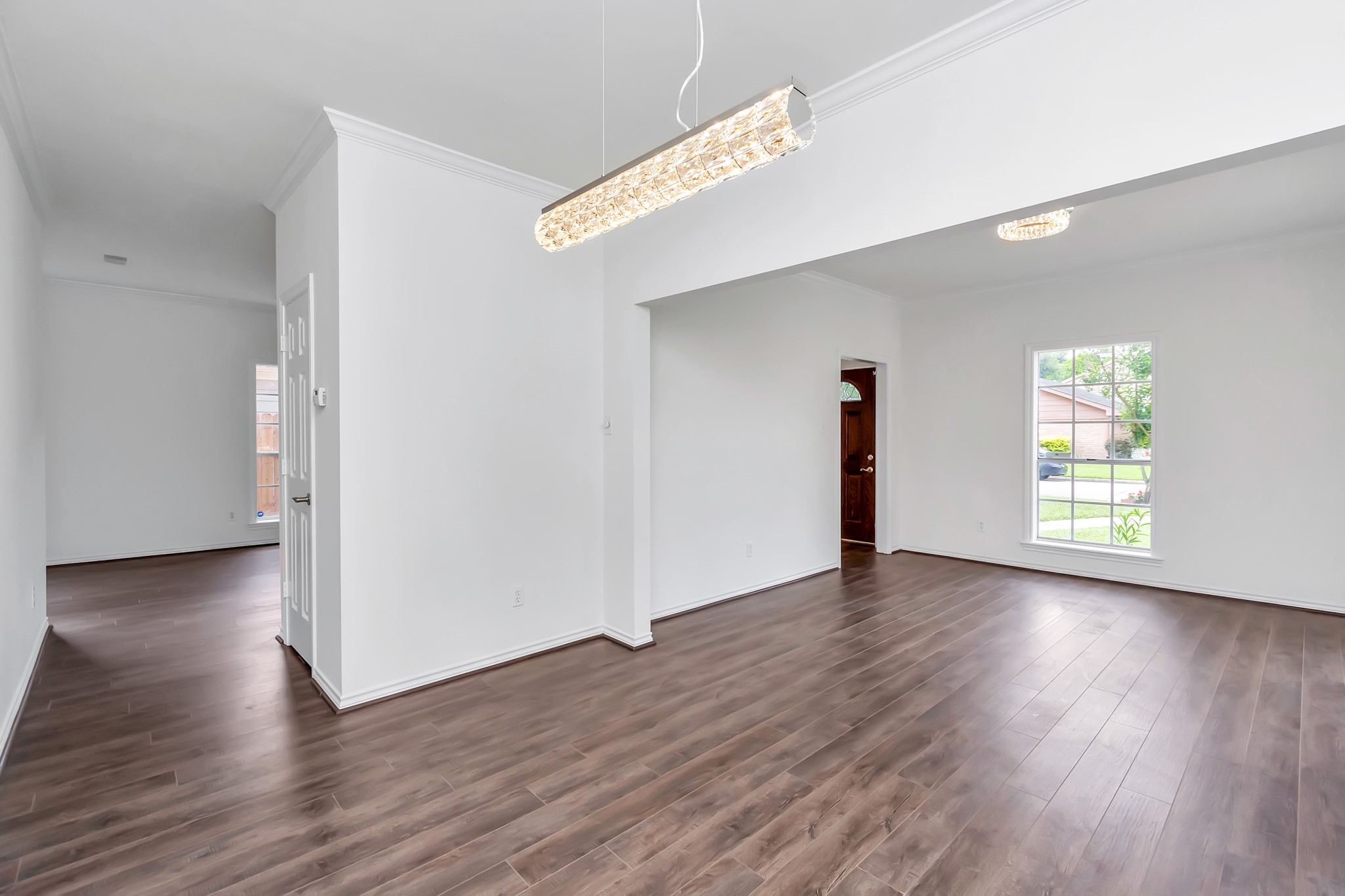 12818 Chamberlain Drive Houston, TX 77077 - Photo 9 of 32 a view of an empty room with wooden floor and a window