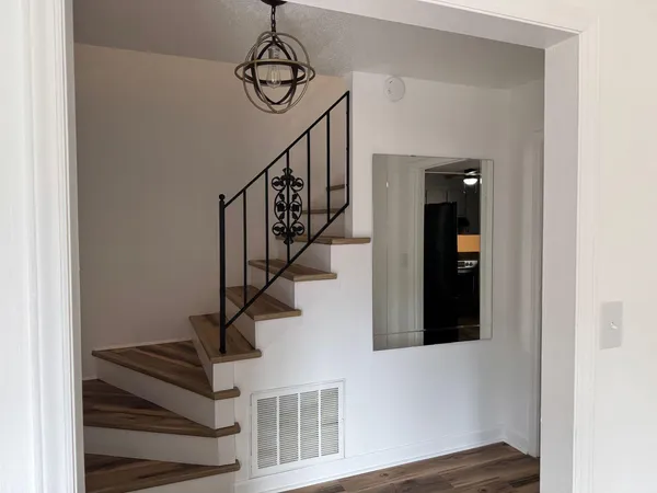 a view of entryway and hall with wooden floor