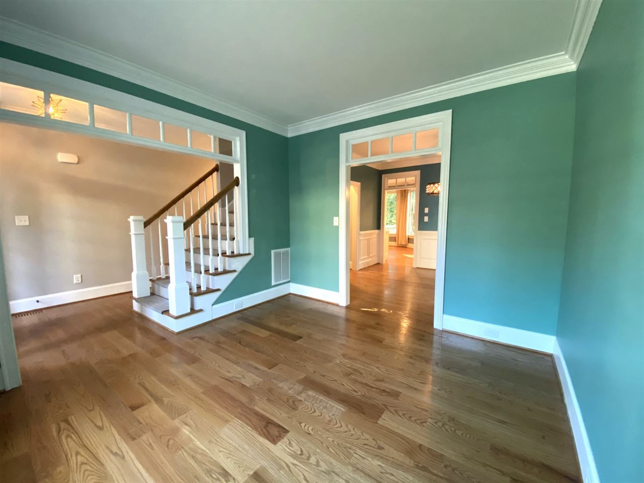 412 Thyme Place Raleigh, NC 27609 - Photo 9 of 26 Gorgeous Site Finished Hardwood Floors on the First Level and Second Level Hallway. View from Living Room into Foyer and Dining Room