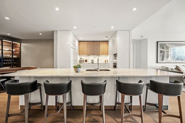 a kitchen with a table chairs sink and cabinets