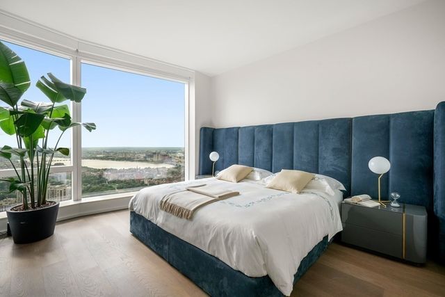 a bedroom with a bed lamp and window