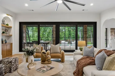 a living room with furniture and floor to ceiling windows
