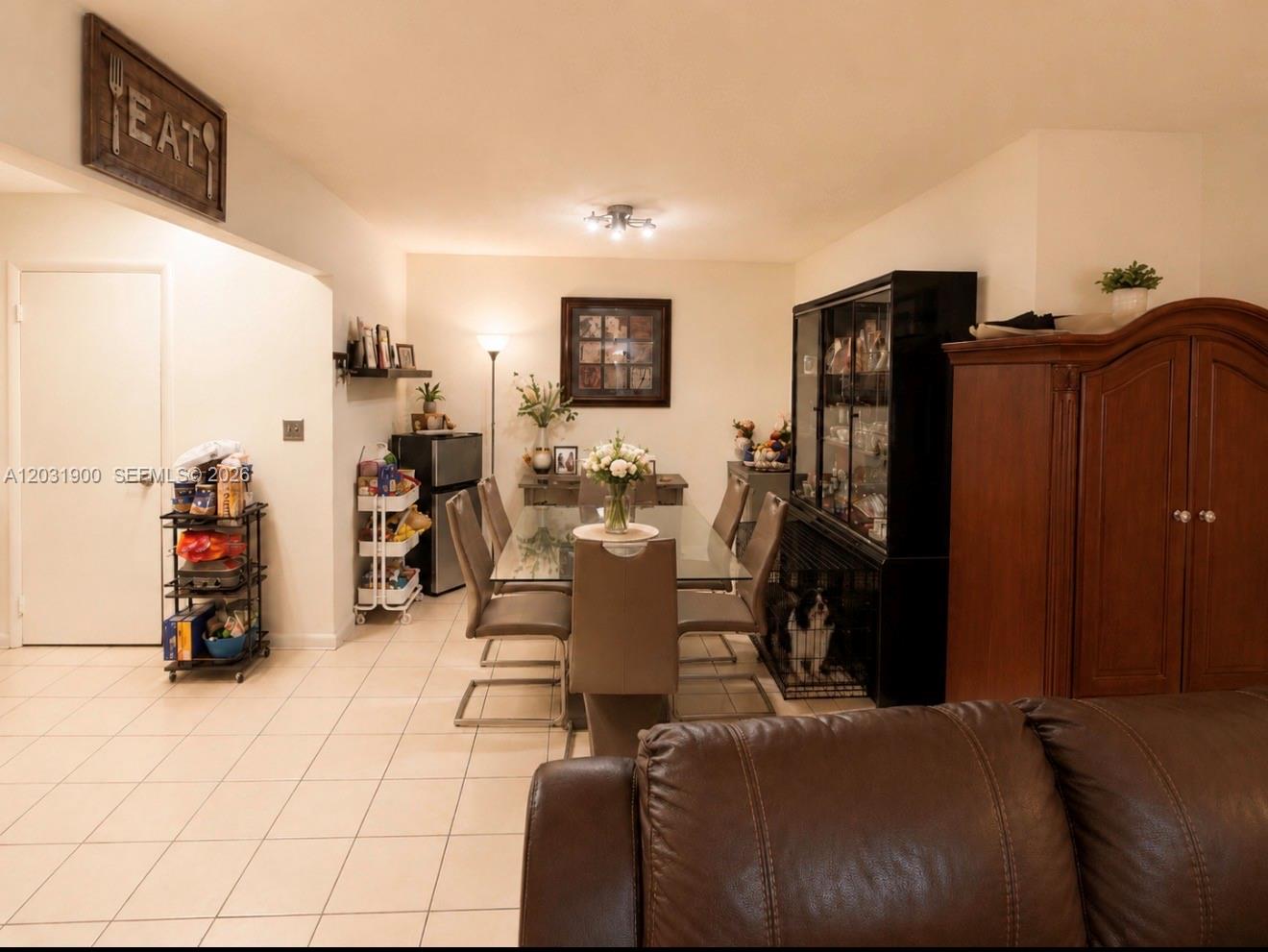 12860 Southwest 43rd Drive, Unit 146B Miami, FL 33175 - Photo 4 of 12 a living room with furniture and a gym machine
