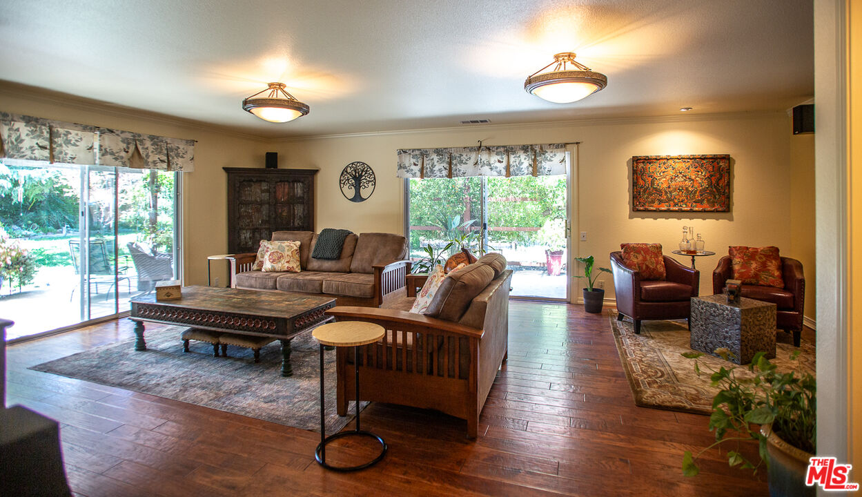 969 Vintage Way Los Alamos, CA 93440 - Photo 13 of 59 a living room with furniture a large window and wooden floor