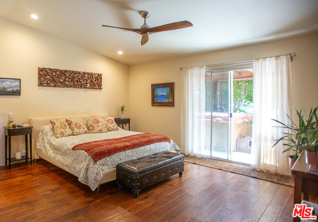969 Vintage Way Los Alamos, CA 93440 - Photo 14 of 59 a bedroom with a large bed and a large window