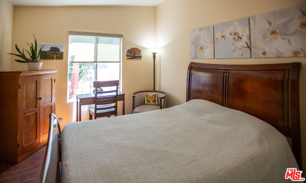 969 Vintage Way Los Alamos, CA 93440 - Photo 18 of 59 a bedroom with a bed table closet and a window