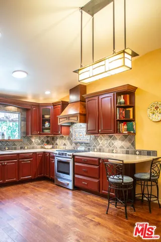 a kitchen with stainless steel appliances granite countertop a sink and cabinets