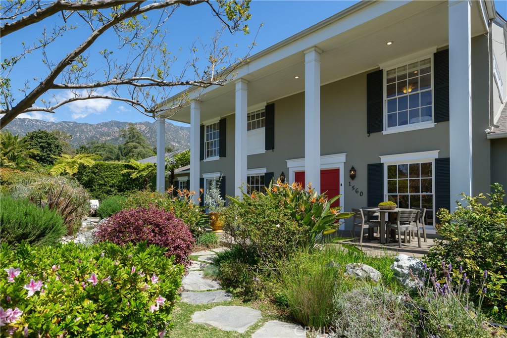a view of a chair and table in the backyard of the house