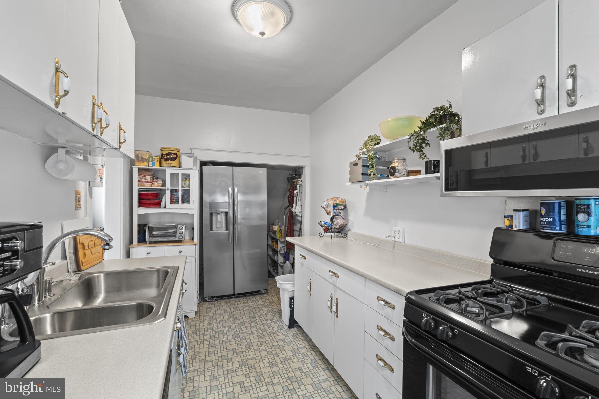 330 Burmont Road Drexel Hill, PA 19026 - Photo 15 of 35 a kitchen with stainless steel appliances granite countertop a sink stove and refrigerator