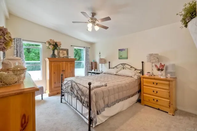 a spacious bedroom with a bed and a chandelier