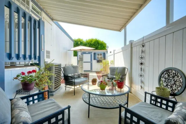a balcony with furniture and a potted plant