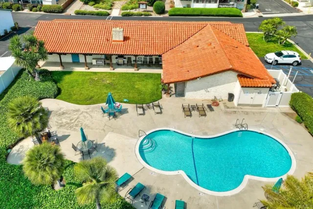 an aerial view of a house with garden space and swimming pool