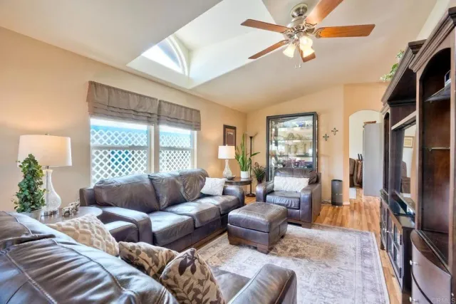 a living room with furniture fireplace and a large window