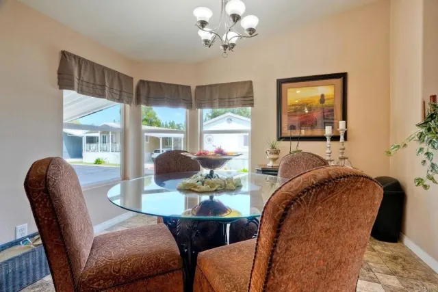 a dining room with furniture and a large window