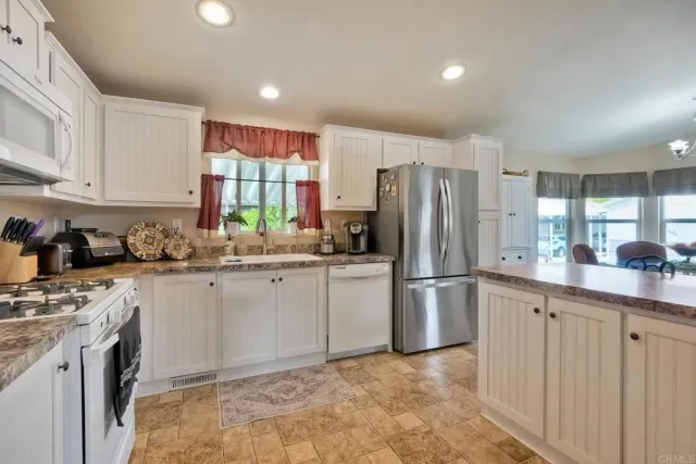 a kitchen with a refrigerator and a sink