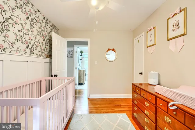 a bedroom with furniture and baby crib