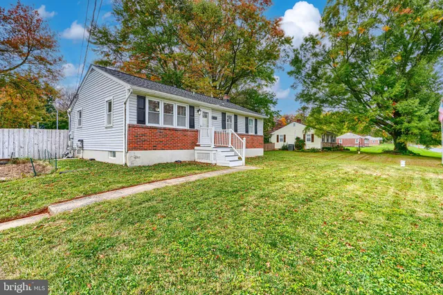 a view of a house with a yard and sitting area