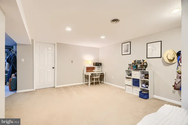 a bathroom with a granite countertop sink a mirror and shower