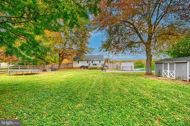 a backyard of a house with lots of green space and fountain