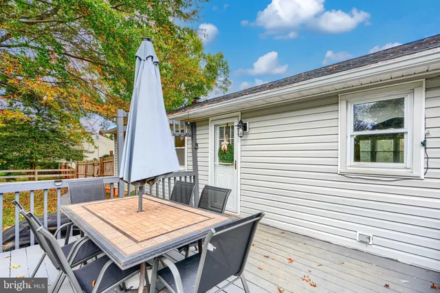 a view of backyard with swimming pool and green space