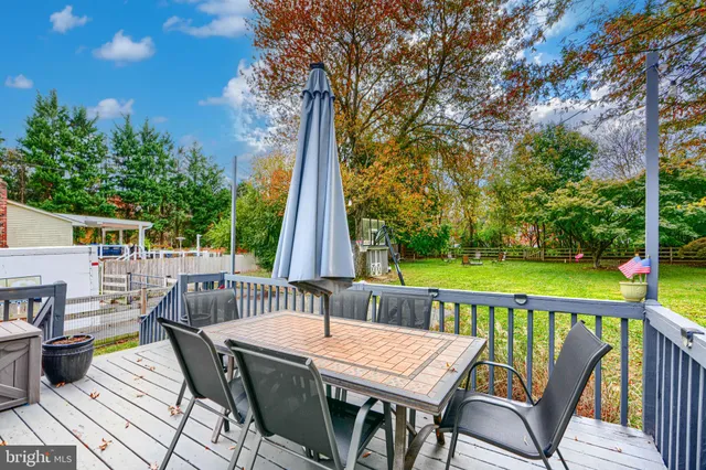 a view of a patio with table and chairs and wooden floor
