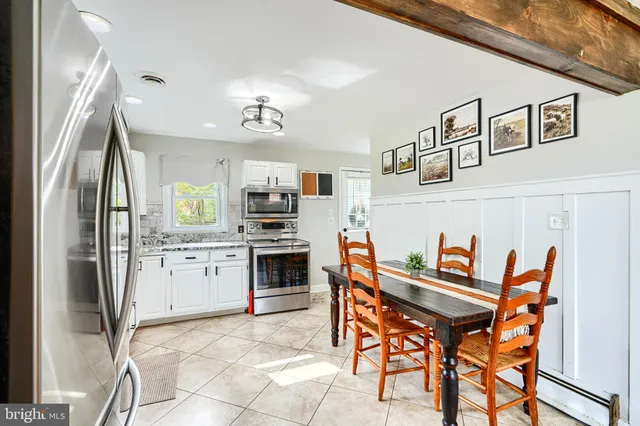 a kitchen with stainless steel appliances kitchen island granite countertop a refrigerator and a stove top oven