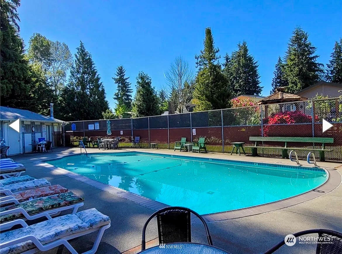 20426 32nd Drive Southeast Bothell, WA 98012 - Photo 23 of 23 a view of a swimming pool with lawn chairs and a fire pit