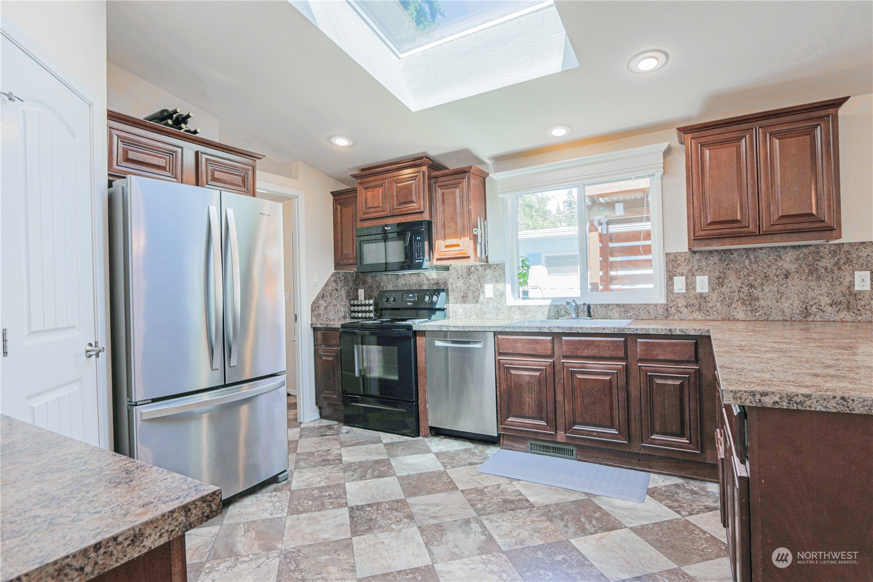 20426 32nd Drive Southeast Bothell, WA 98012 - Photo 5 of 23 a kitchen with stainless steel appliances granite countertop a refrigerator stove top oven and sink