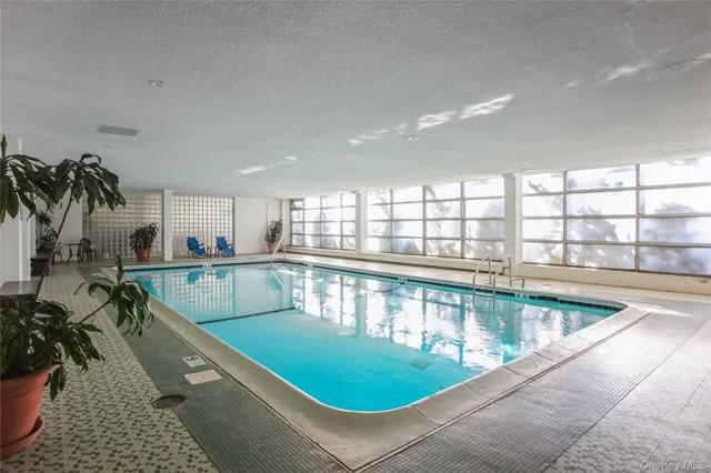 a view of a swimming pool and outdoor seating