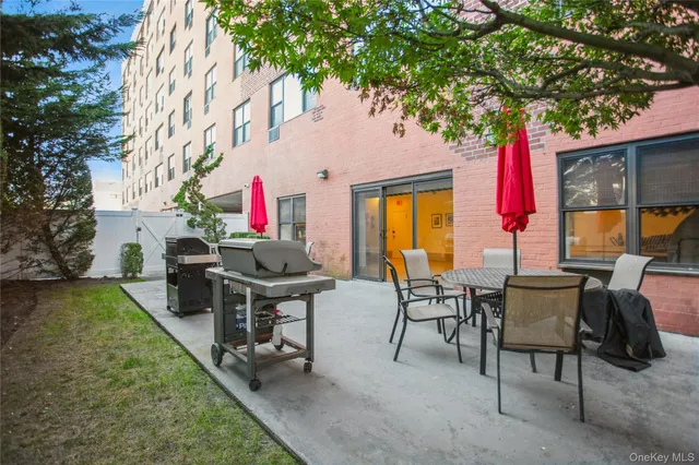 an outdoor sitting area with couch and wooden fence