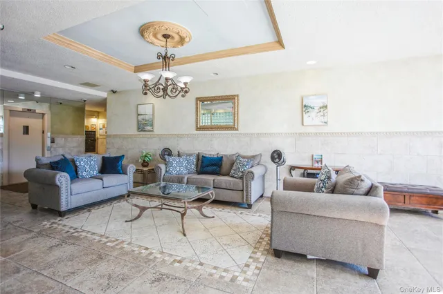 a living room with furniture and a chandelier