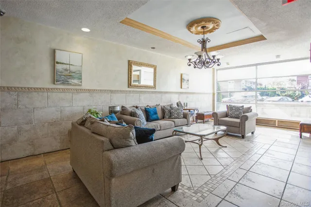 a living room with furniture and a chandelier