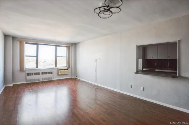 a view of a livingroom with wooden floor and a window