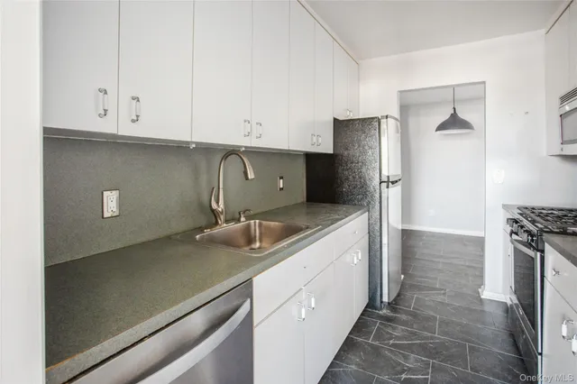 a kitchen with a sink appliances and cabinets