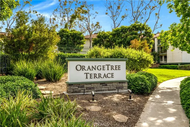 a sign broad in front of red brick house