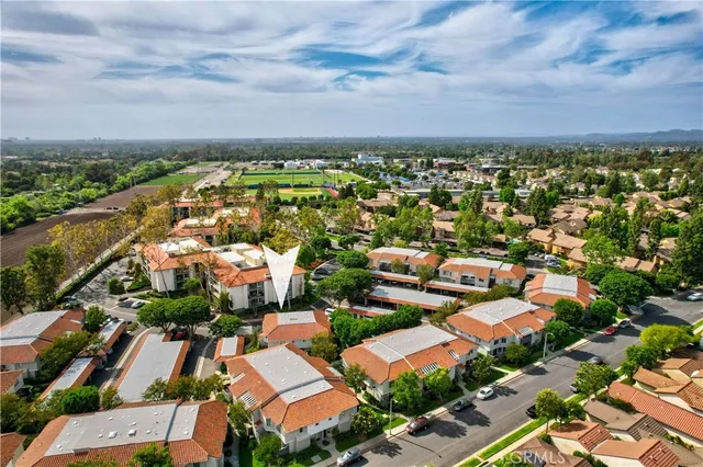 an aerial view of residential houses with outdoor space
