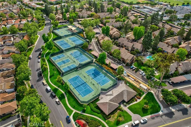 an aerial view of a residential houses with yard