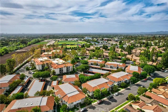 an aerial view of residential houses with outdoor space
