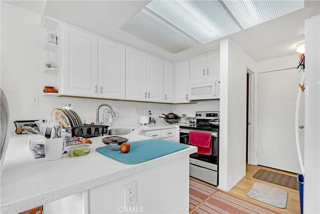 a kitchen with a refrigerator and cabinets