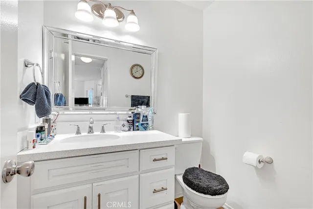 a bathroom with a toilet a sink and mirror