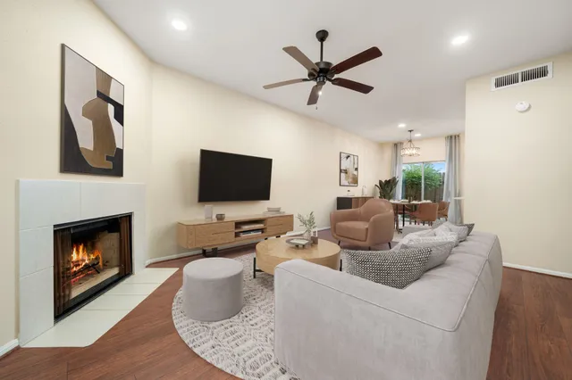a living room with furniture a fireplace and a flat screen tv