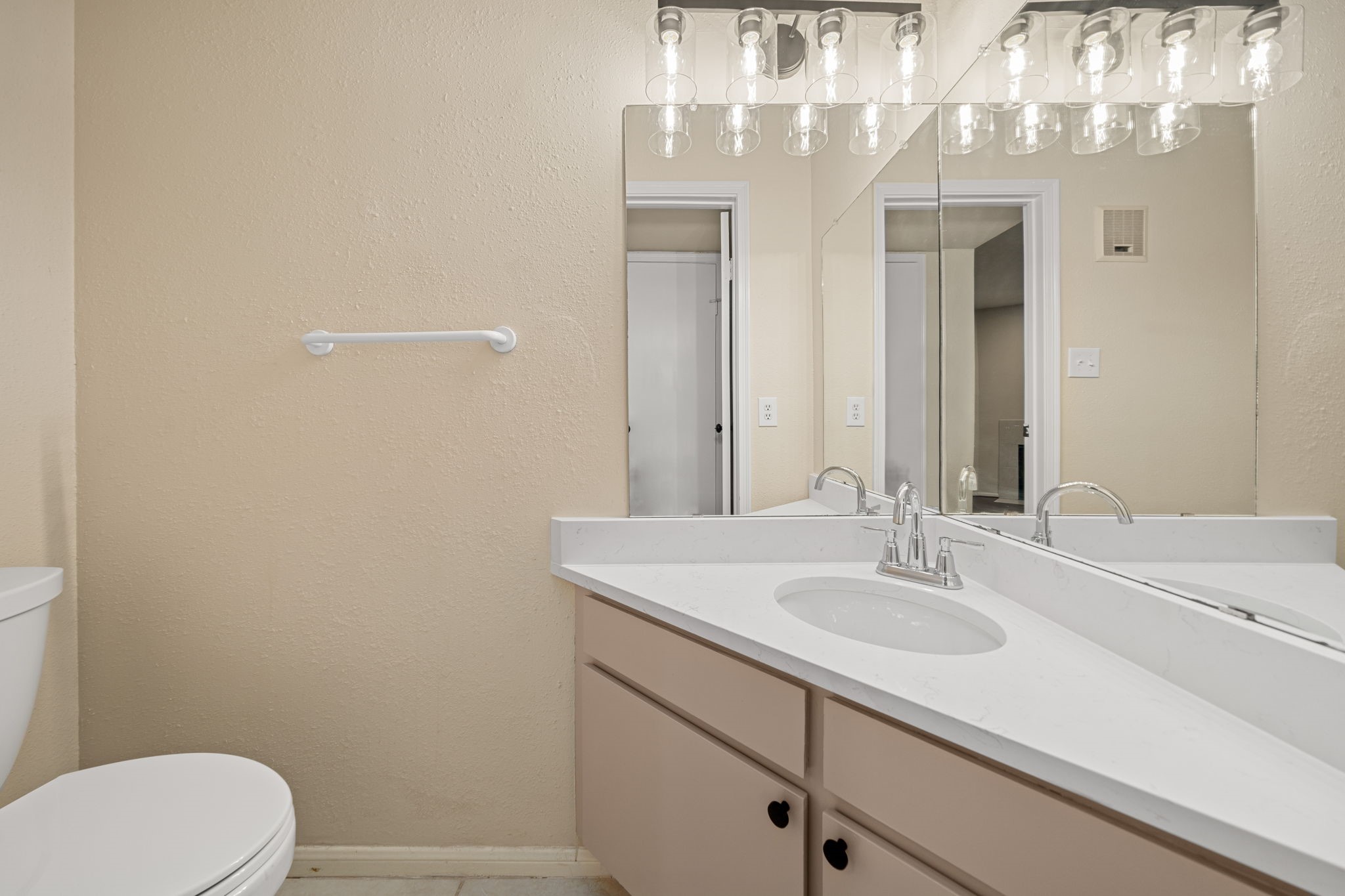 7575 Cambridge Street, Unit 1604 Houston, TX 77054 - Photo 11 of 26 a bathroom with a sink a toilet and a mirror