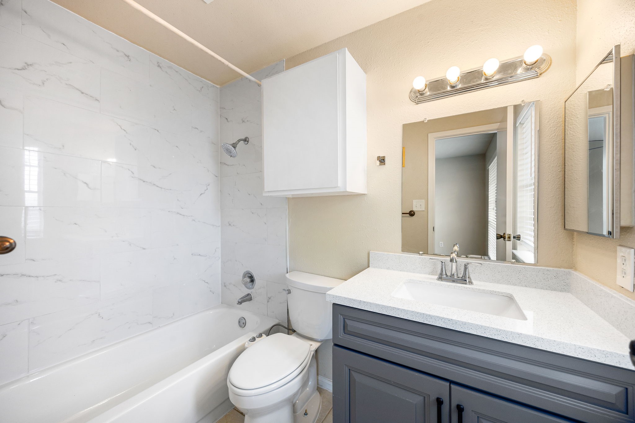 7575 Cambridge Street, Unit 1604 Houston, TX 77054 - Photo 19 of 26 a bathroom with a sink a toilet and shower