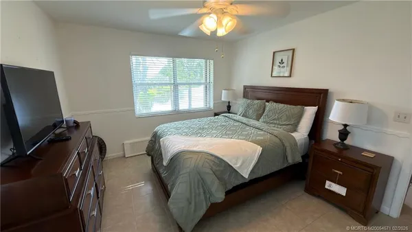 a bed sitting in a bedroom next to a window