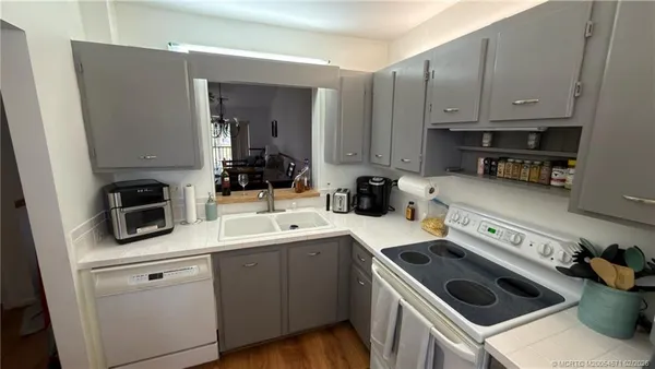 a kitchen with a stove and white cabinets