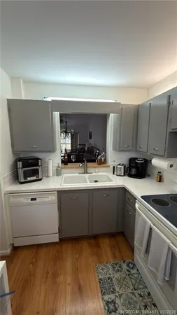 a kitchen with a sink and white cabinets