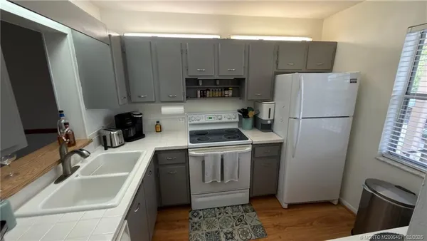 a kitchen with a sink cabinets and stainless steel appliances
